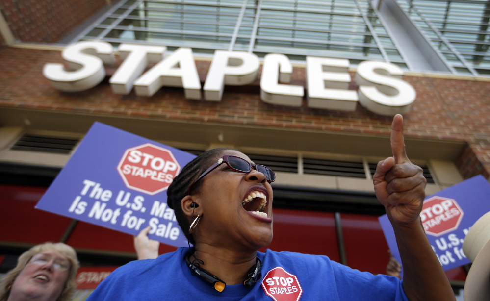 U.S. Post Office employee Detra Parker chants Thursday during a protest outside a Staples store in Atlanta. Thousands of postal workers picketed outside Staples stores nationwide Thursday to protest a pilot program that allows the office supply chain to handle U.S. mail.