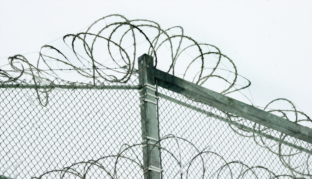 Razor wire is coiled along the top of the security fence at the Maine State Prison in Warren. State officials have made substantial improvements to policies on the use of segregation to punish disruptive inmates.
