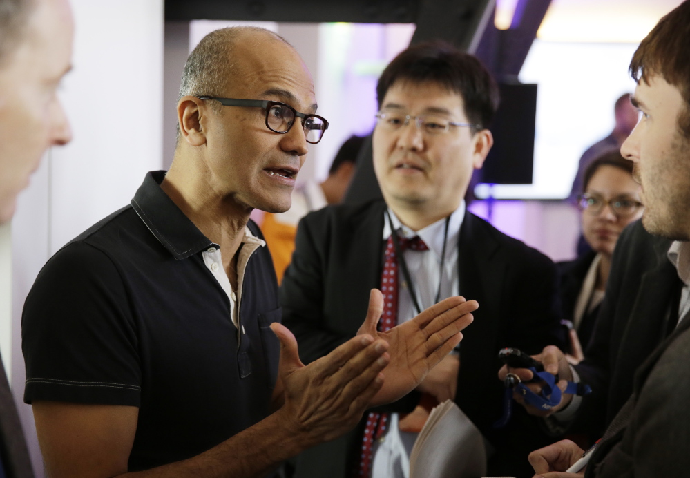 Microsoft CEO Satya Nadella, who replaced longtime CEO Steve Ballmer in February, gestures while speaking with reporters after giving a news briefing on the intersection of cloud and mobile computing on March 27 in San Francisco.