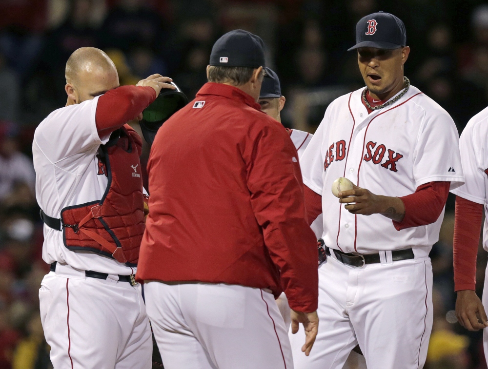 Boston Red Sox starting pitcher Felix Doubront, right, hands the ball to manager John Farrell as he is taken out while trailing the New York Yankees in the third inning Thursday in Boston. Red Sox catcher David Ross is at left.