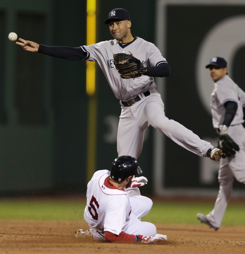 Yankees shortstop Derek Jeter makes the force-out on Boston’s Jonny Gomes on a single hit by Xander Bogaerts in the second inning.