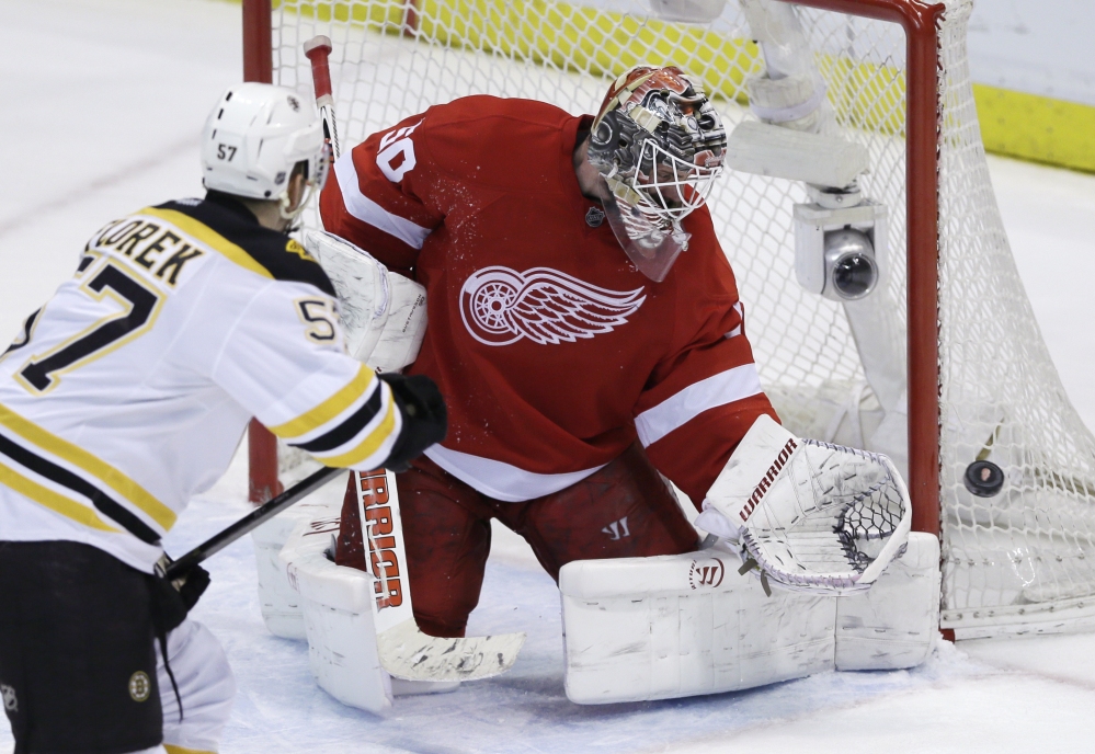Detroit Red Wings goalie Jonas Gustavsson deflects a shot by Boston Bruins left wing Justin Florek in the third period of Game 4 of first-round NHL playoff series in Detroit on Thursday.
