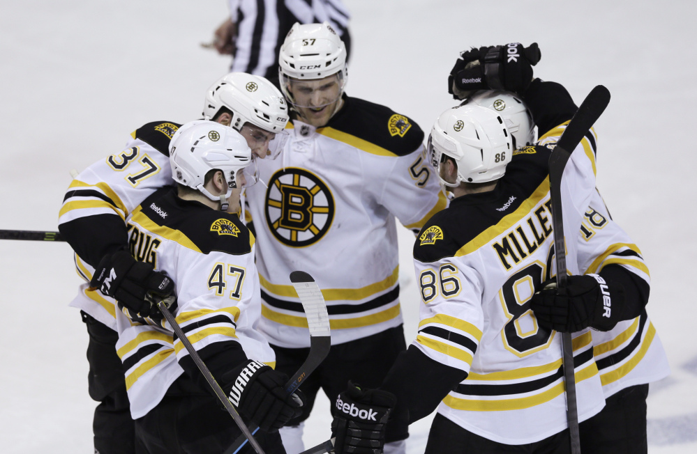 Boston Bruins, clockwise from foreground left, Torey Krug, Patrice Bergeron, Justin Florek, Reilly Smith and Kevan Miller celebrate Krug’s goal in the second period Thursday.