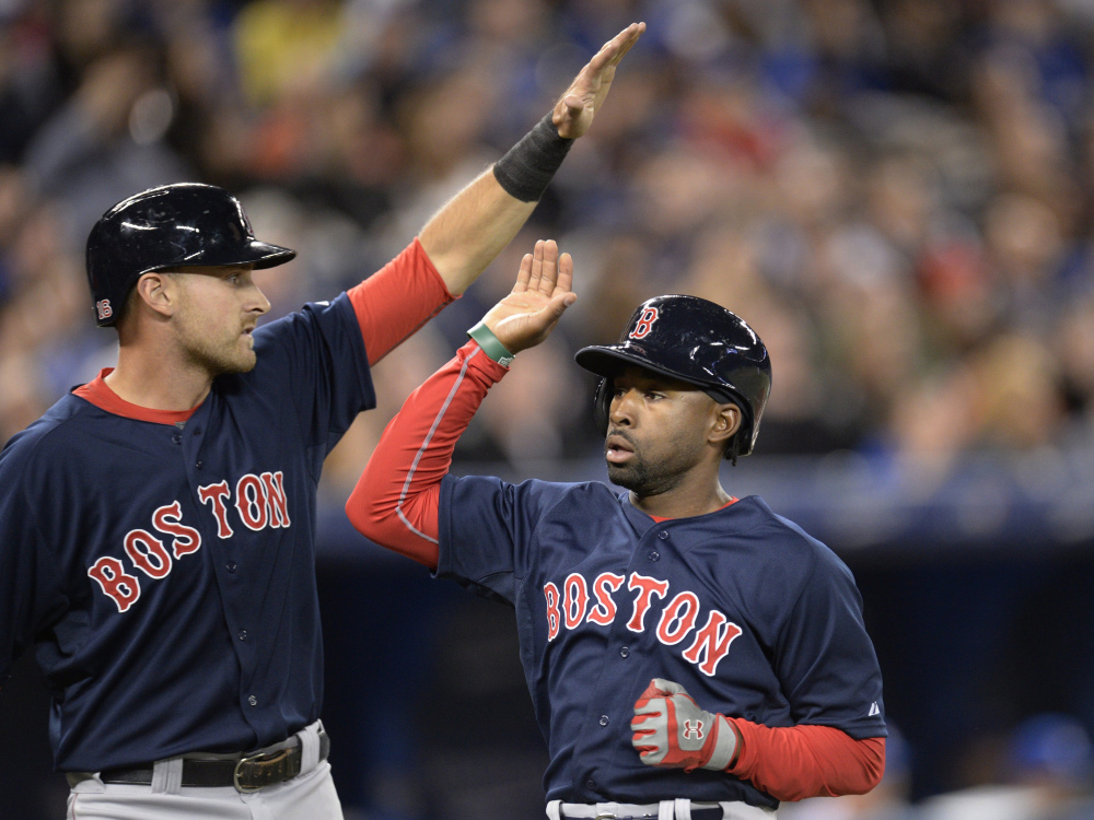 Will Middlebrooks, back from the disabled list, celebrates with Jackie Bradley Jr. after they scored on a single by Dustin Pedroia in the second inning.