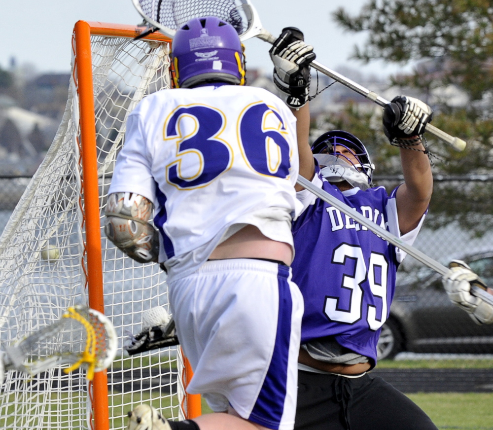 Frank Curran of Cheverus finds enough room to send the ball past Deering goalkeeper Lenny Sarem during their SMAA lacrosse game Friday at Cheverus High. Cheverus improved to 1-1 with a 17-7 victory in Deering’s opening game.