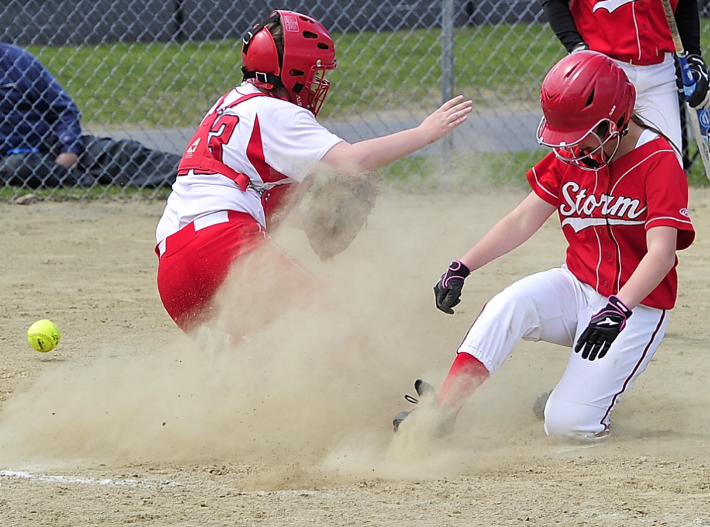Chloe Gorey of Scarborough slides home safeley as the ball gets past South Portland catcher Kiley Kennedy during Friday’s SMAA softball game in Scarborough. Scarborough won, 13-4.