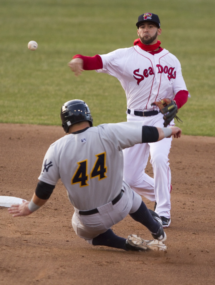 Shortstop Deven Marrero of the Portland Sea Dogs fires to first as Kyle Roller of the Trenton Thunder tries unsuccessfully to break up a double play during Trenton’s 14-10 victory at Hadlock Field. The Thunder scored four runs in the ninth inning to pull away from a 10-10 tie.