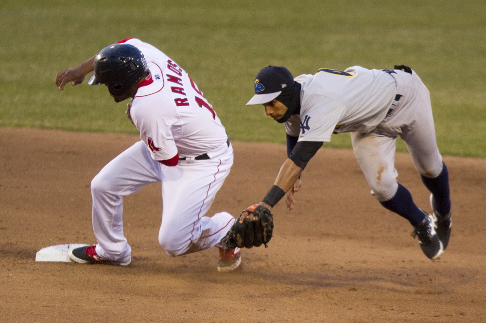 Henry Ramos of the Portland Sea Dogs pulls safely into second base Friday night as shortstop Ali Castillo of the Trenton Thunder tries to handle the throw.