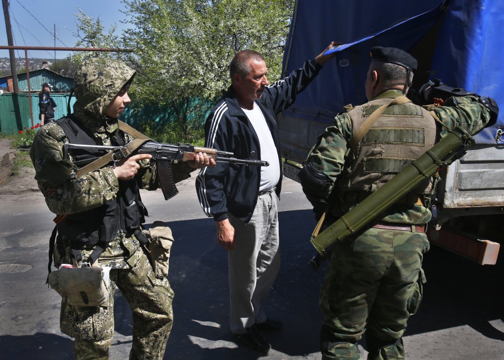 Pro-Russian armed militants inspect a truck near Slovyansk, eastern Ukraine, on Friday. Russian Foreign Minister Sergey Lavrov has accused the West of plotting to control Ukraine.