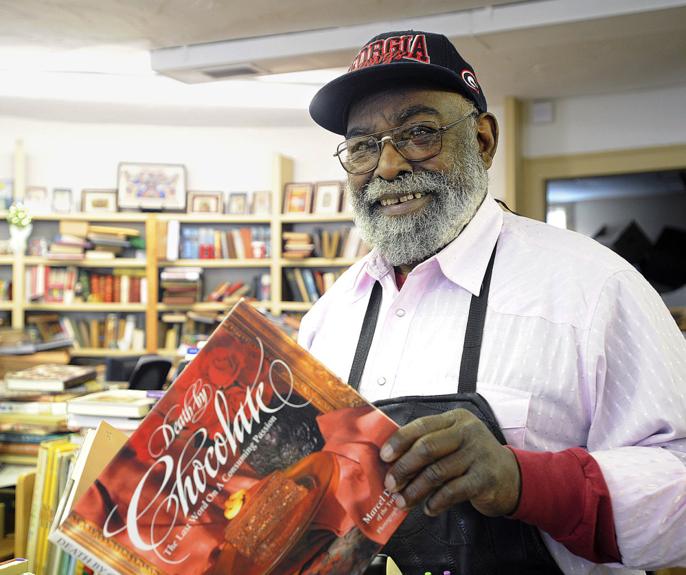 Eagle Trading Co. owner Chuck Williams holds one of his favorite old cookbooks at his store in Assonet, Mass. He and his store are solely devoted to finding and selling out-of-print and hard-to-find cookbooks.