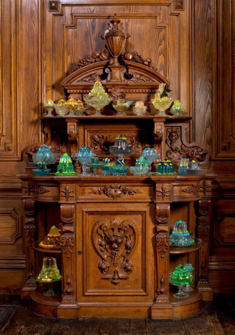 Dozens of fancy gelatin resin sculptures by Mark Dion and Dana Sherwood populate cupboards in the Victoria Mansion dining room.