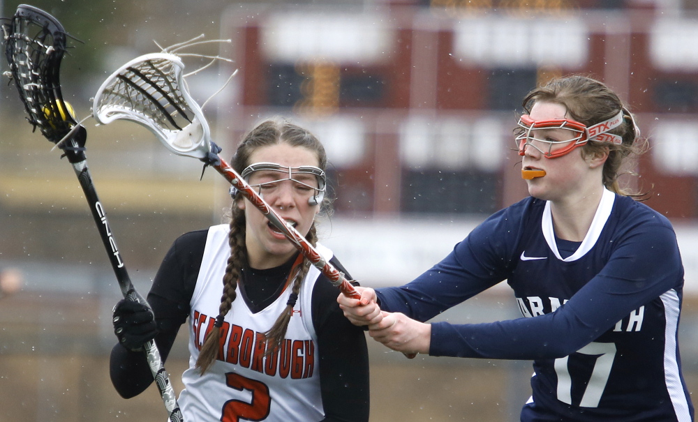 Abby Corbin, left, of Scarborough tries to get past Yarmouth’s Mary Coyne. The Red Storm avenged a loss in last year’s season opener.
