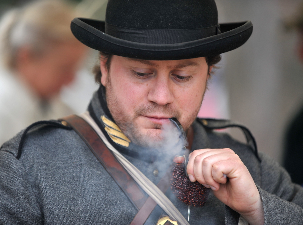 Dave Laiche, captain of the 15th Alabama, Company G, smokes a vintage pipe Saturday during a Civil War re-enactment at Abbott Park in Farmington.