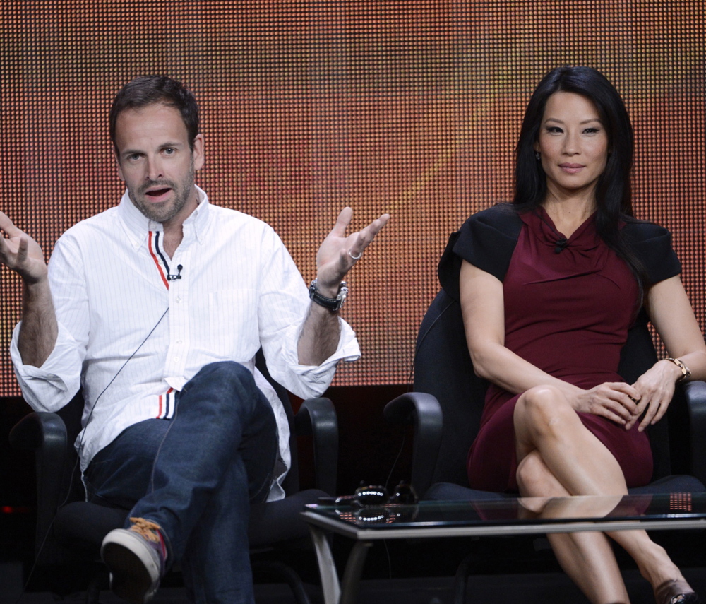 Cast members Jonny Lee Miller and Lucy Liu participate in a panel for CBS series "Elementary" during the CBS sessions at the Television Critics Association in 2012.