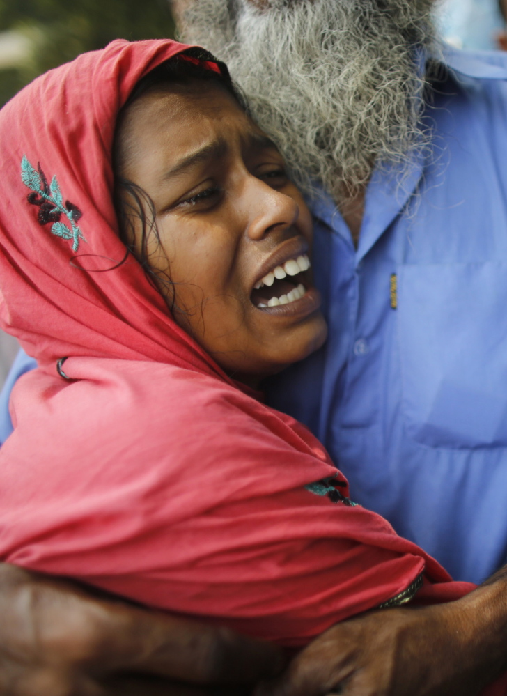A woman mourns her husband, who died in the collapse of the Rana Plaza factory in Bangladesh last year. The injured and family members of those killed are still waiting for compensation.
