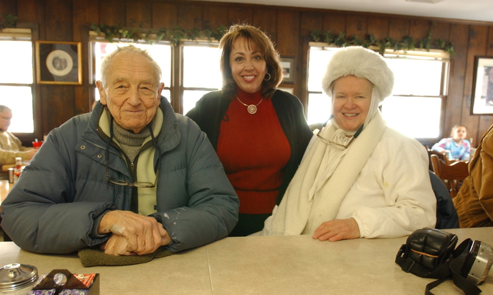 Artist Andrew Wyeth, shown with Helga Testorf, right, and Hank’s Place co-owner Voula Skiadas center, in Chadds Ford, Pa., in 2003.