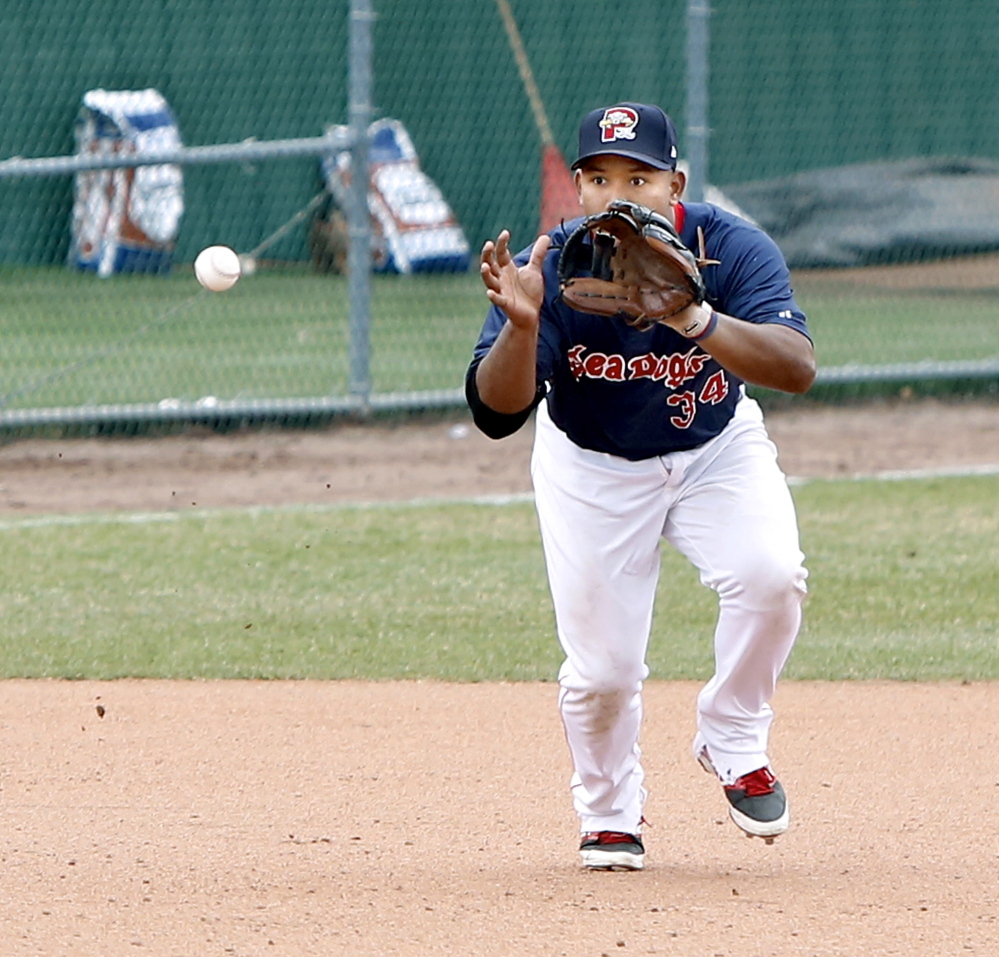 Sea Dogs third baseman Heiker Meneses watches a ground ball into his glove against the Trenton Thunder on Sunday.