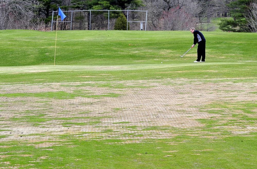 Andy McInnis of Portland, a member of Riverside Golf Course for the past 20 years, putts Monday on the temporary green at the 6th hole. It is one of many greens that have been adversely affected by winter ice at Riverside and other local courses. “This is the worst I’ve seen it,” McInnis said.