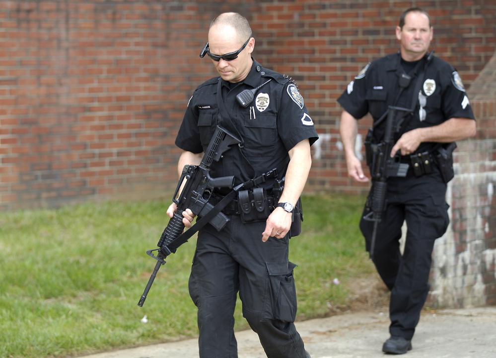 Greensboro police officers leave after after clearing Marteena Hall as North Carolina A&T State University locked down some buildings Monday while police searched for a man who was reported to be carrying a rifle on campus, in Greensboro, N.C. The lockdown was lifted after a search failed to find any sign of the reported gunman.