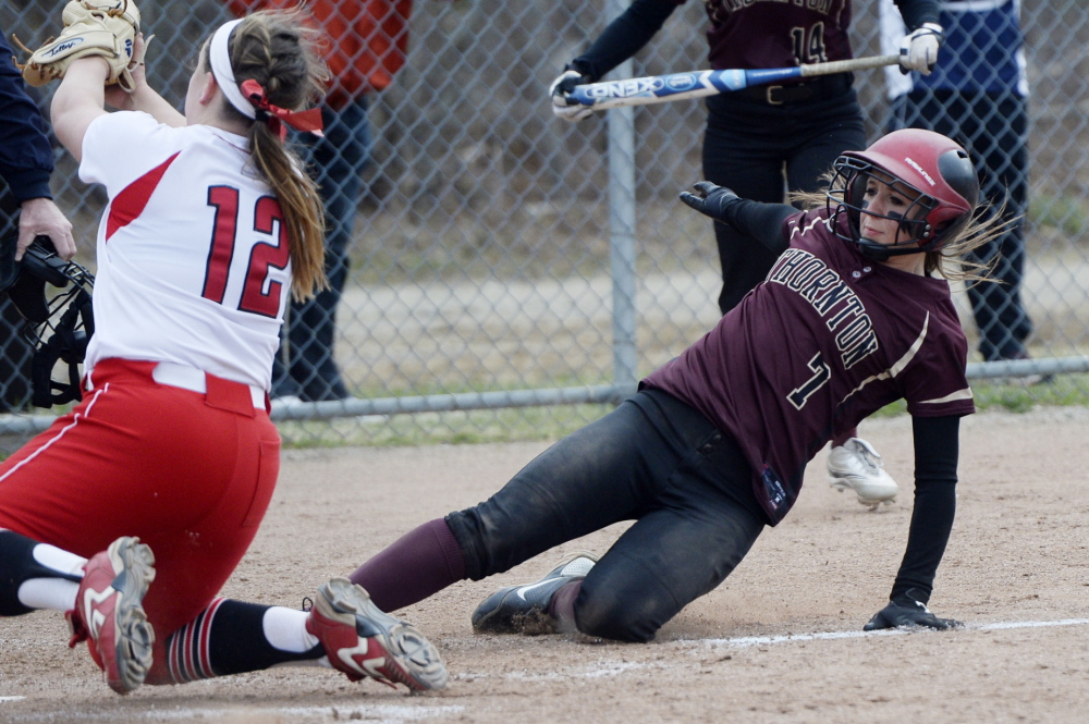 Thornton Academy’s Brooke Cross slides safely into home as South Portland pitcher Olivia Indorf fields the catcher’s throw after a wild pitch during a 4-3 softball win by South Portland on Monday.