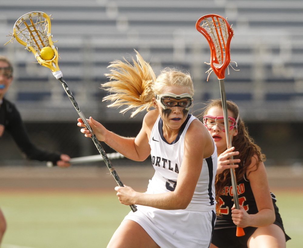 Hallie Allex of Portland works the ball down the field Tuesday while pursued by Rebekah Guay of Biddeford during Portland’s 9-8 victory at Fitzpatrick Stadium.