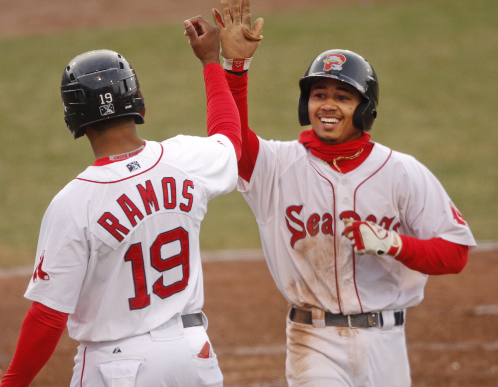 Mookie Betts high-fives Henry Ramos as he crosses home plate with a three-run homer in the fourth inning against the Reading Fightin Phils at Hadlock Field in Portland on May 13.