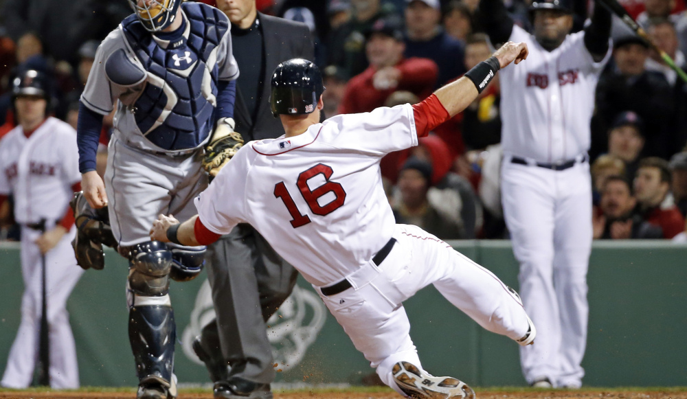 Boston Red Sox's Will Middlebrooks (16) slides safely into home on a sacrifice fly by Shane Victorino as Tampa Bay Rays catcher Ryan Hanigan watches during the fifth inning of a baseball game at Fenway Park in Boston, Tuesday, April 29, 2014. (AP Photo/Elise Amendola)