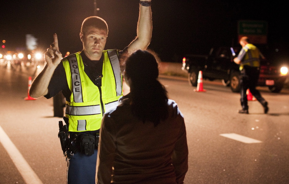 Cumberland police Officer Ryan Martin conducts a field sobriety test in Brunswick last summer. Maine’s governor has vetoed legislation targeting the state’s worst drunken-driving offenders.