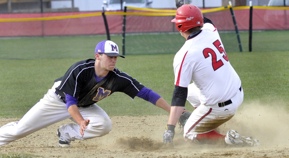 Noah McDaniel of Marshwood makes a late tag Tuesday as Ben Greenberg of Scarborough slides safely into second base with a steal. Marshwood won, 4-2.