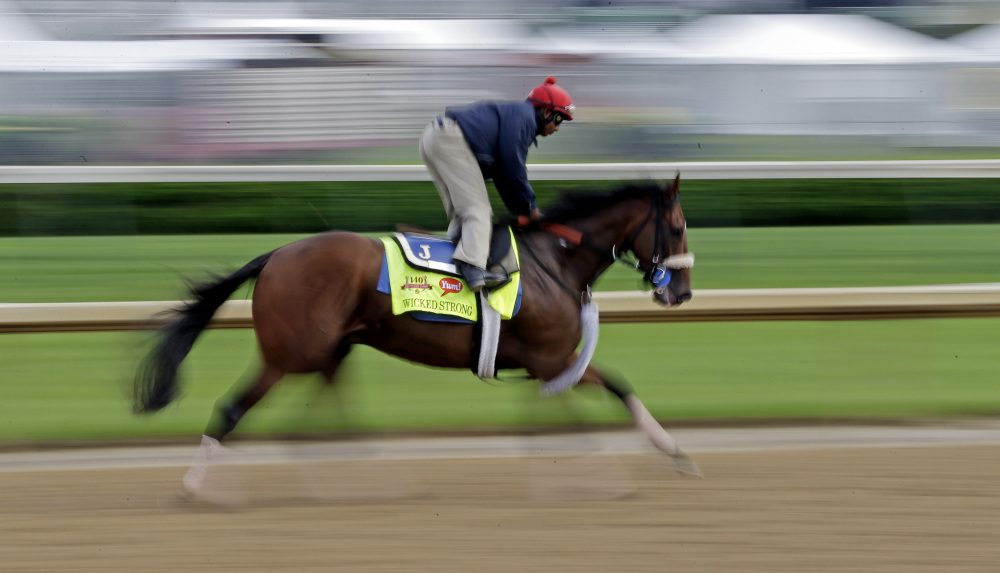 Exercise rider Kelvin Pahal takes Kentucky Derby hopeful Wicked Strong for a morning workout at Churchill Downs on Tuesday in Louisville, Ky.