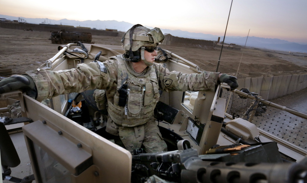 Sgt. Eric Crabtree of Hope, a gunner with a Convoy Escort Team of the 133rd Engineer Battalion of the Maine Army National Guard, rides in the gun turret during tests before departing on a convoy to Bagram Air Field in Afghanistan last winter.