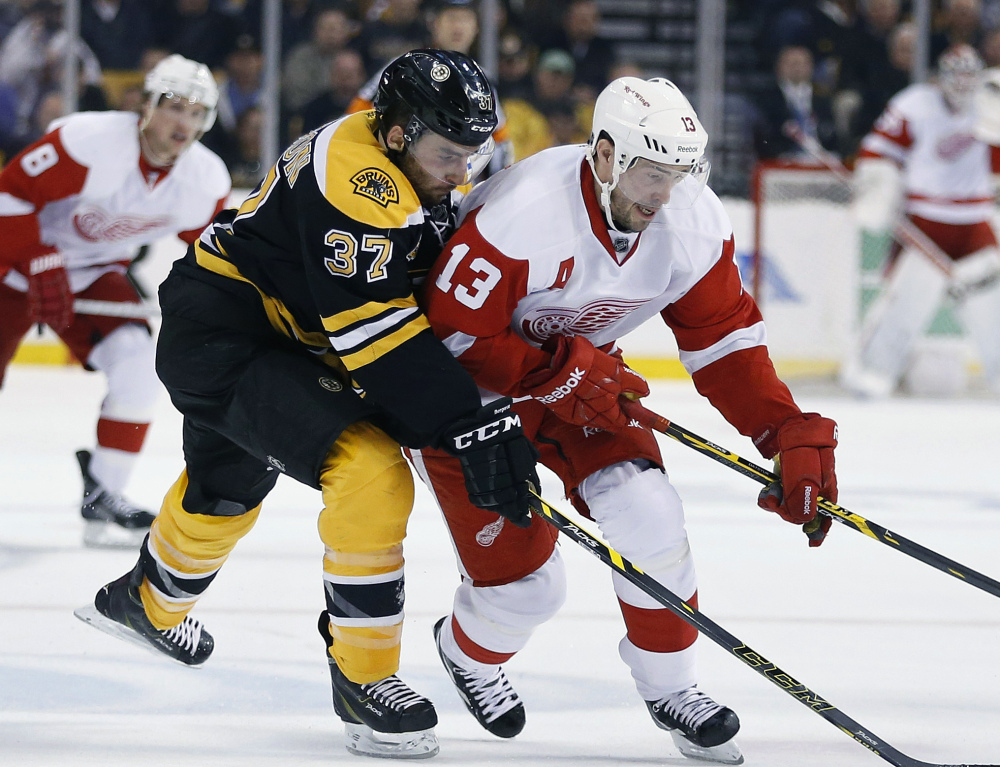 Boston’s Patrice Bergeron, left, seen battling Detroit’s Pavel Datsyuk during Game 5 of their first-round series, is one of the three award nominees who lead a stingy Bruins defense.