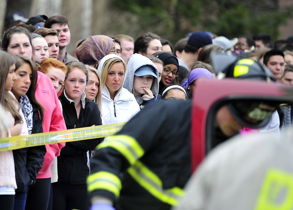 Students react with somber expressions as Portland High School’s Students Against Destructive Decisions sponsor a simulated accident to give students awareness about their behavior and driving habits. Participating in the simulation on Wednesday were the Portland Fire Department, Portland Police Department, Medcu and A.T. Hutchins Funeral Home as well as eight students from SADD who acted as the injured and deceased victims of the accident.