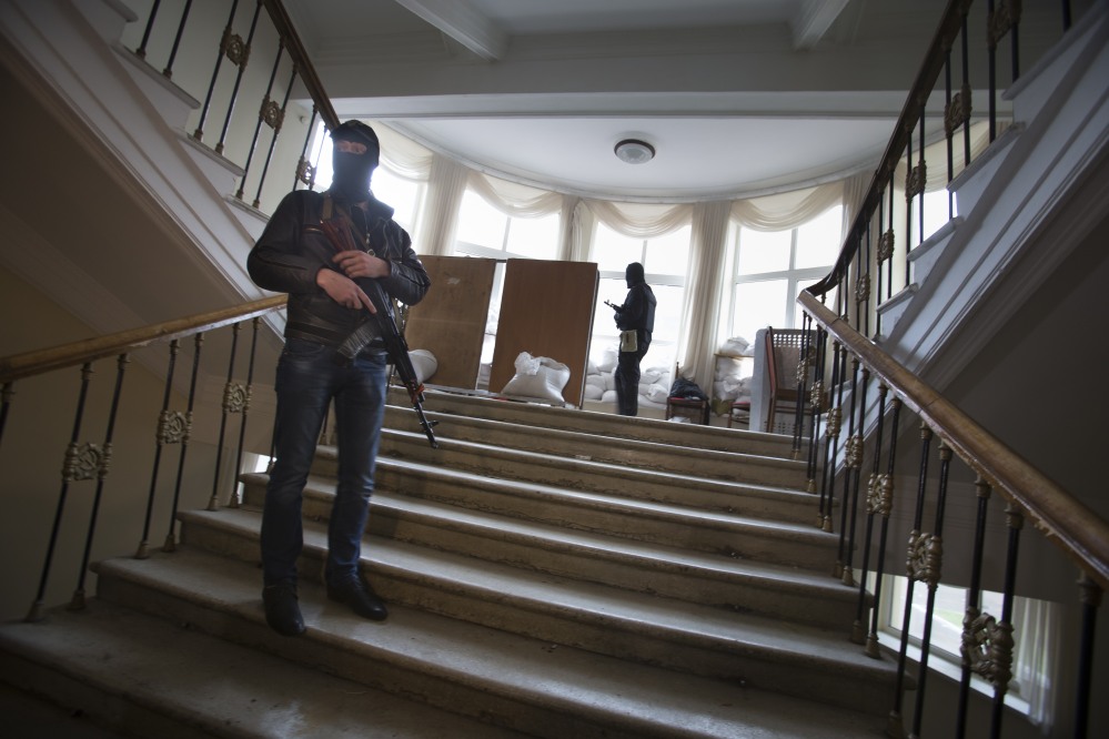 Pro-Russian gunmen guard an administration building they seized Tuesday in Luhansk, one of the largest cities in eastern, Ukraine,