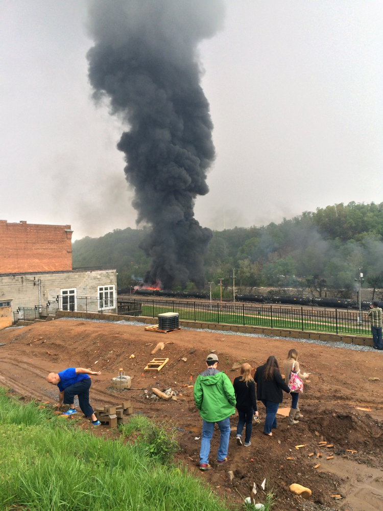 Smoke rises after several CSX tanker cars carrying crude oil derailed and caught fire Wednesday in Lynchburg, Va. Authorities evacuated numerous buildings after the derailment.