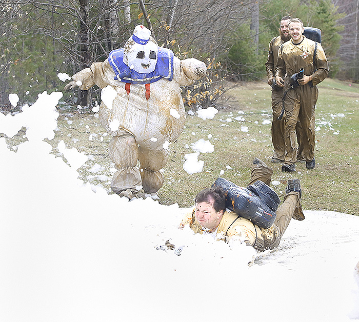 Brian Alley of Bangor, dressed as one of the “ghostbusters” from the 1984 "Ghostbusters" movie, dives through the foam across the Mud Challenge finish line Sunday accompanied by Mike Hager of Ellsworth, dressed as the Stay Puft Marshmallow Man. Right behind them, also portraying ghostbusters, are Alley’s brothers Shawn and Derek Alley.