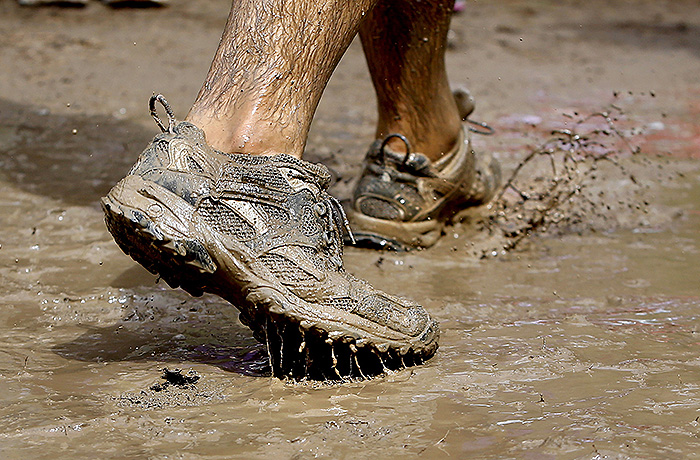 A runner splashes his way through the Mud Challenge course. Participants came from across the state, many wearing elaborate get-ups in hopes of winning the costume contest.
