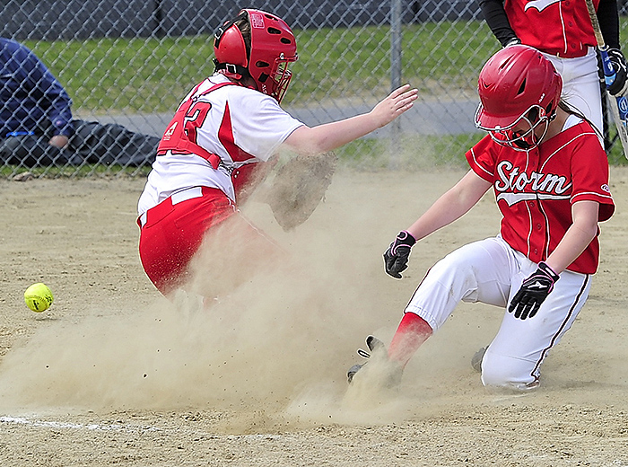 Chloe Gorey of Scarborough slides home safely as the ball gets past South Portland catcher Kiley Kennedy during Scarborough’s 13-4 victory at home Friday. Gorey drove in three runs with two hits.