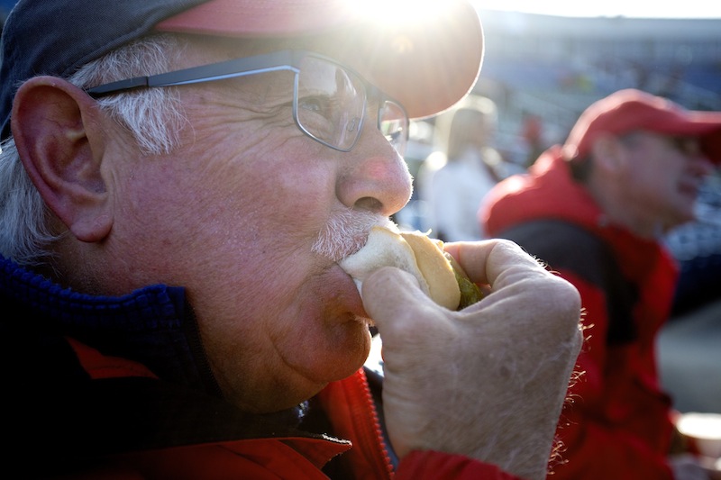 Ken Caprio of Scarborough bites into a hot dog before the start of the Portland Sea Dogs season opener at Hadlock Field. Caprio has owned season tickets since the Sea Dogs franchise started in 1994.