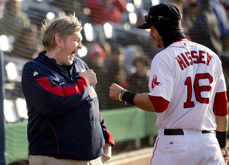 Craig Candage, clubhouse manager for the Portland Sea Dogs, shares a laugh with outfielder Peter Hissey before the start of Portland's home opener at Hadlock Field, Thursday, April 10, 2014.