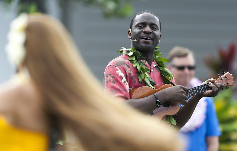 In this January 2014 file photo, a hula dancer plays a ukulele before the start of a golf tournament in Kapalua, Hawaii. Hawaii is debating whether to make the ukulele or the steel guitar it state instrument.