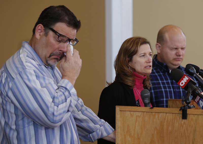 Will Corporon, left, and Tony Corporon, right, fight emotions while Mindy Losen, center, talks about her son and father during a news conference at their church in Leawood, Kan., Monday, April 14, 2014. Dr. William Corporon and his 14-year-old grandson were victims of Sunday's shooting at the Jewish Community Center. The three are sons and daughter of Dr. Corporon and Losen is the mother of the 14-year-old victim.