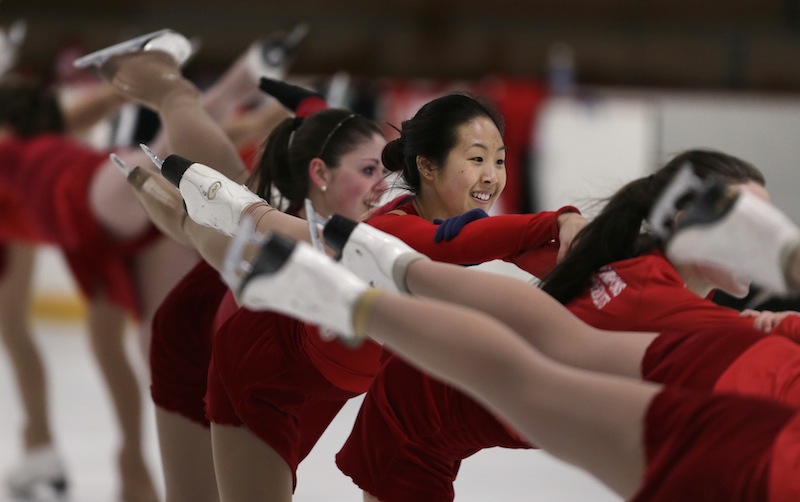 In this Wednesday, March 19, 2014 photo, Devin Wang, a Boston University student and skater with the USA synchronized skating team known as the Haydenettes, practices in Lexington, Mass. Wang, along with bystander Carlos Arredondo and EMT Paul Mitchell, are credited with helping to save the life of Jeff Bauman, who suffered traumatic injuries in the Boston Marathon bombings.