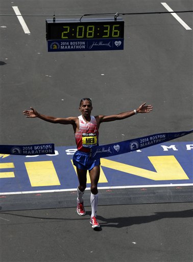 Meb Keflezighi of San Diego, Calif., breaks the tape to win the 118th Boston Marathon.