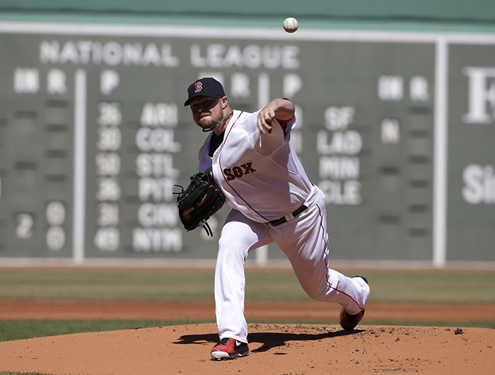 Boston Red Sox's Jon Lester delivers a pitch against the Milwaukee Brewers in the first inning of Sunday's game in Boston.