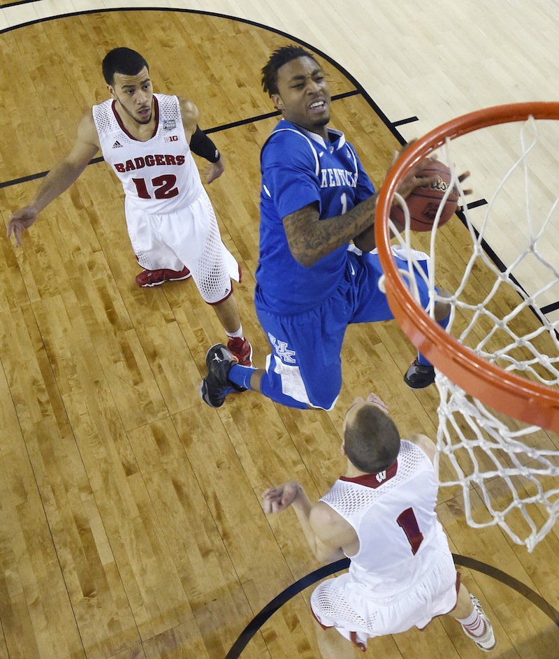 In this April 5 photo, Kentucky guard James Young, center, drives to the basket between Wisconsin guard Traevon Jackson, left, and guard Ben Brust, right, during the first half of an NCAA Final Four tournament game. Young has declared for the NBA Draft. March Madness