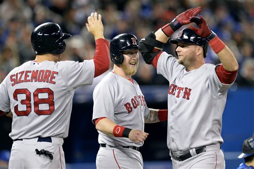 Boston's A.J. Pierzynski, right, is congratulated by Mike Carp, center, and Grady Sizemore after hitting a grand slam during the third inning against the Blue Jays in Toronto on Saturday. Blue Jays;athlete;athletes;athletic;athletics;Canada;Canadian;Center;Centre;competative;compete;competing;competition;competitions;event;game;Jays;League;Major;MLB;pro;professional;Rogers;sport;sporting;sports;Toronto;baseball;American;AL;2014