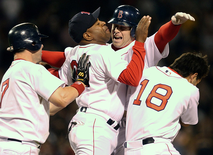 Boston Red Sox players, from left, Trot Nixon, first base coach Dallas Williams, Shea Hillenbrand and Johnny Damon celebrate after Hillenbrand drove in the winning run in the ninth inning against the Tampa Bay Devil Rays in this April 15, 2003, photo. The Red Sox won 6-5 in Boston.