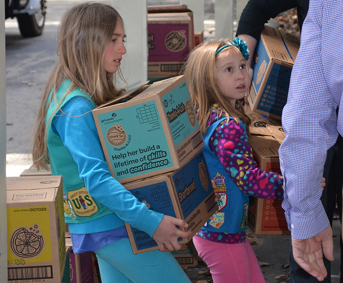 Girl Scouts Ella and Lillian Denis help deliver cookie orders following a cookie drive benefiting Meals on Wheels recipients in York and Cumberland counties as part of the Girl Scouts Cookie Share initiative.