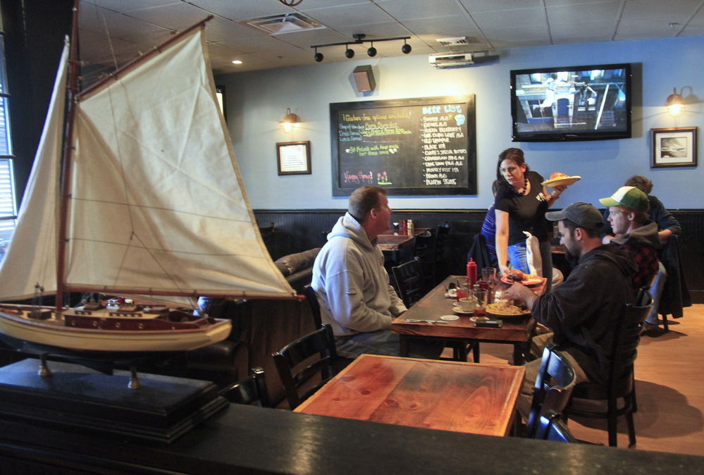 Melissa O’Leary of Eliot serves lunch to customers at the Shipyard Brew Pub. Though located in an unremarkable strip mall, the Eliot pub is remarkable for its friendly atmosphere and picky-eater-pleasing clam chowder.